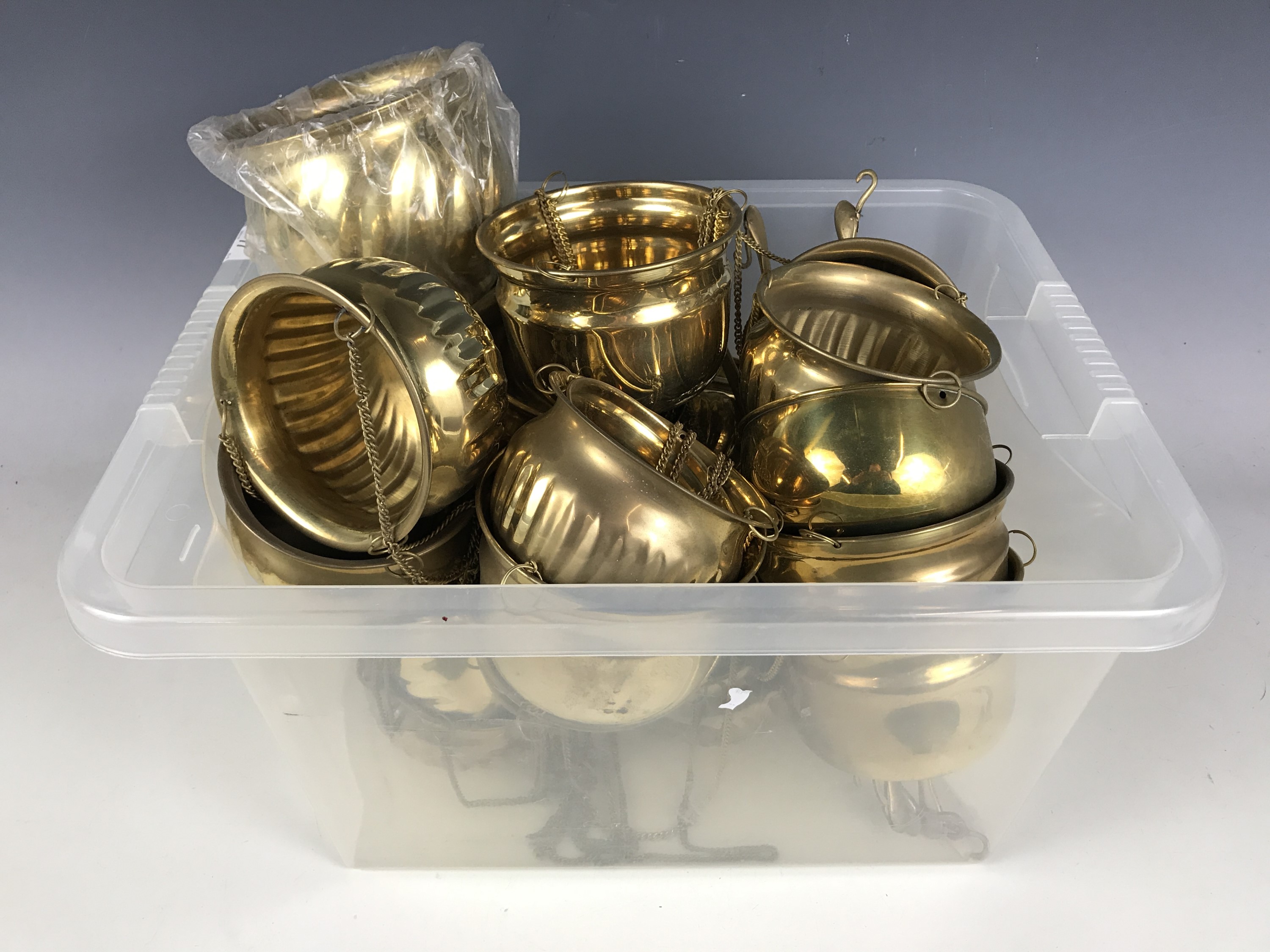 A quantity of new-old-stock pendant brass planters