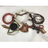 A Colorado Saddlery Co 8' supreme bull whip together with two lassos, a canteen, a miniature saddle,