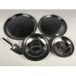 Two Borrowdale stainless steel trays together with two Borrowdale bowls and a cake slice