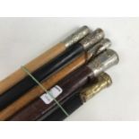 Three Army swagger sticks and two military whips