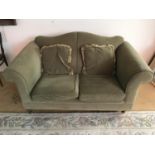 A contemporary green two seater sofa