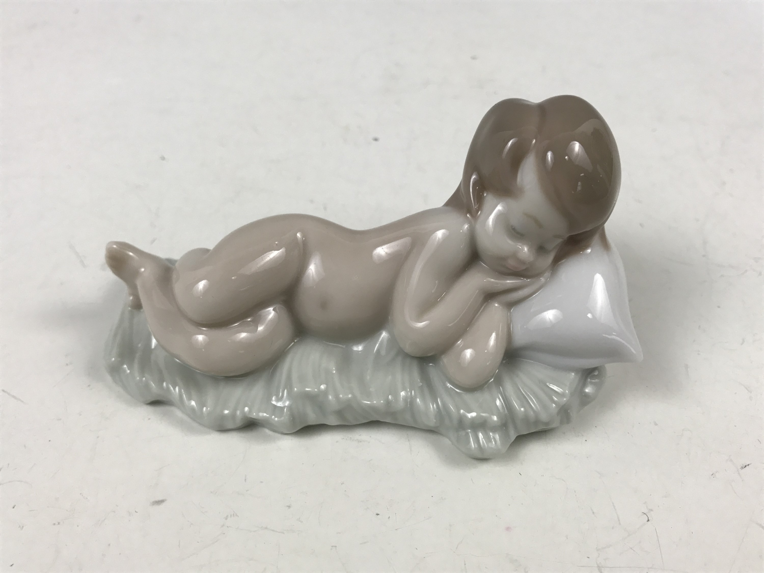 A Lladro figurine modelled as a sleeping baby