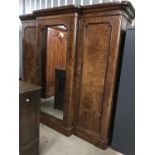 A Victorian burr walnut break-front wardrobe having central projecting mirrored door opening to