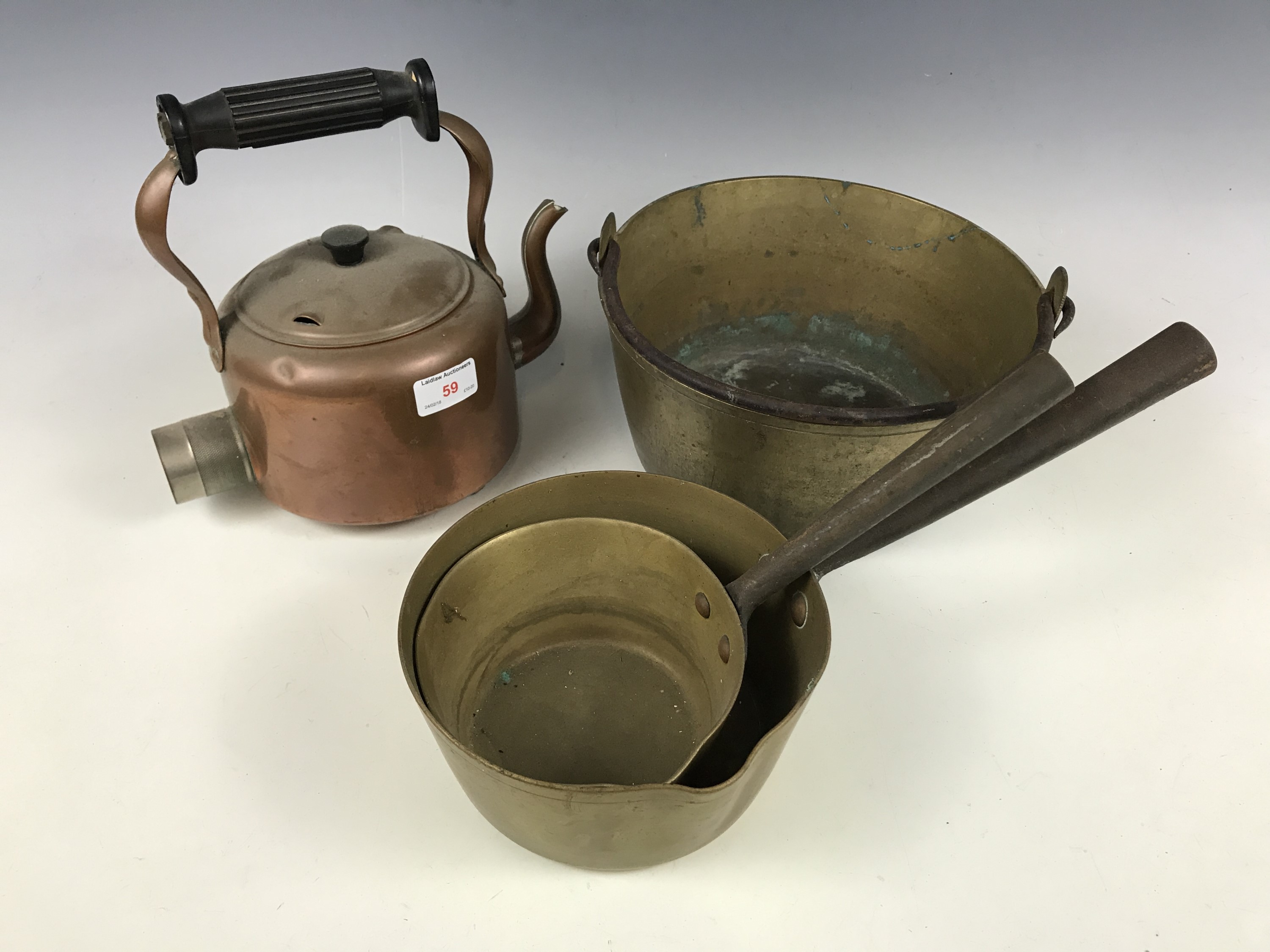 A brass jam pan together with a kettle and two pans