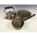 A brass jam pan together with a kettle and two pans