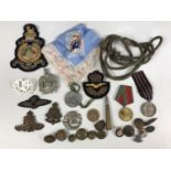 Sundry military medals and badges together with an inert .303 cartridge etc