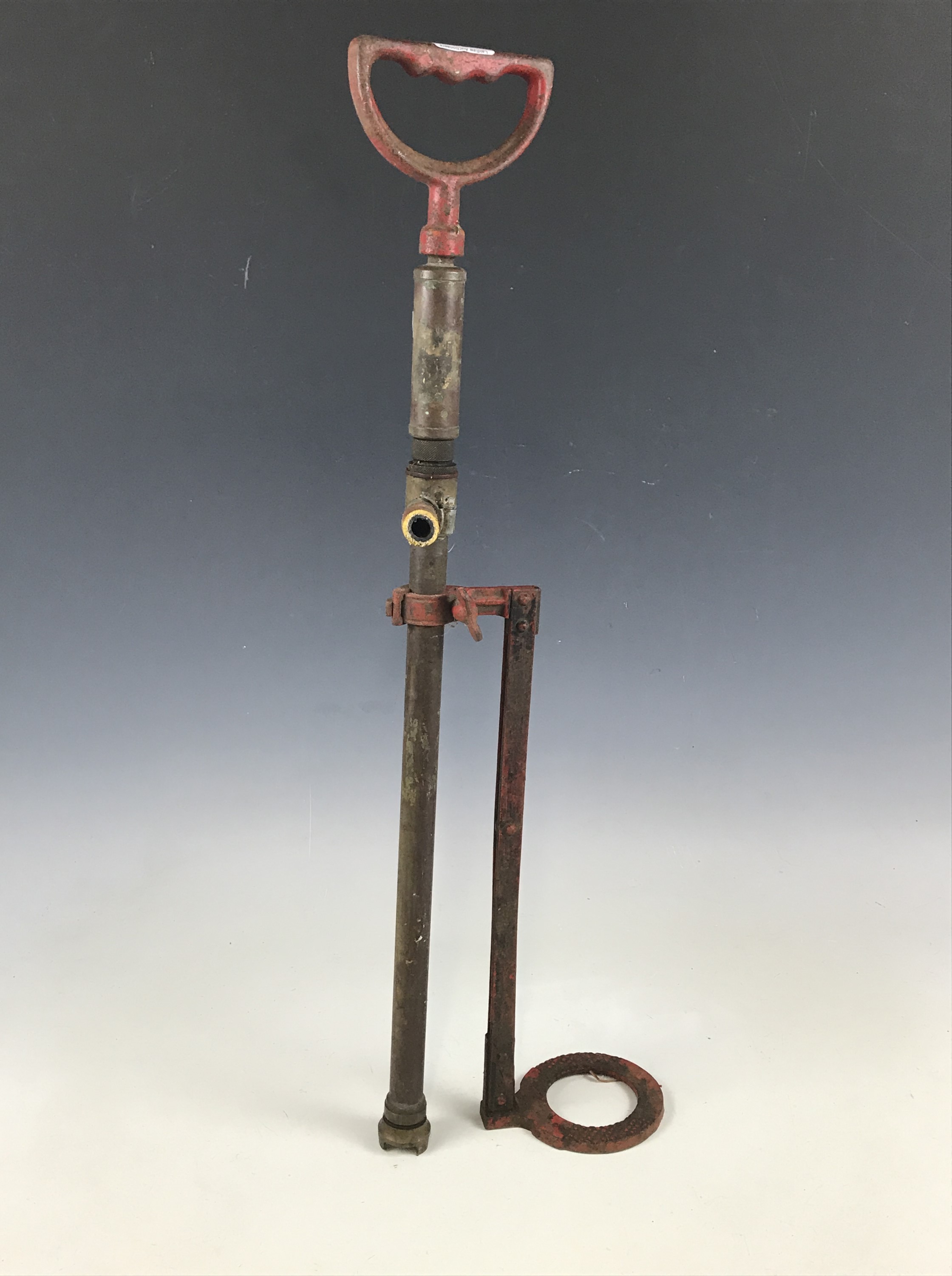 A brass stirrup pump