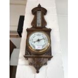 A Victorian carved oak banjo barometer