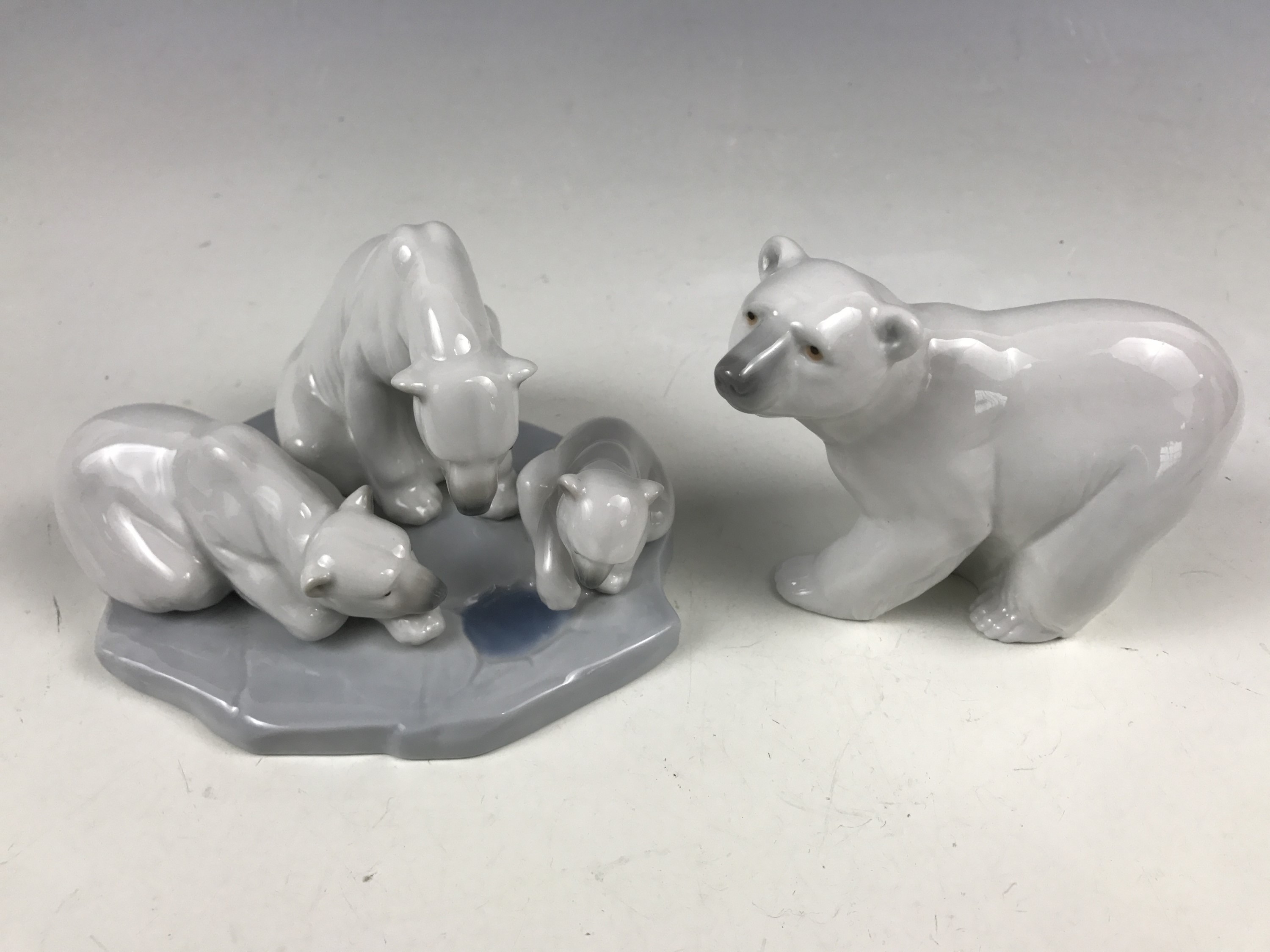 A Lladro porcelain figurine modelled as a polar bear with cubs, model 1443, together with a Lladro