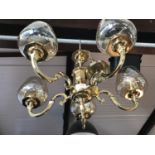 A reproduction brass chandelier with cut glass shades