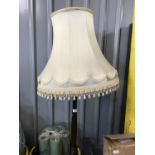 A turned and carved wooden standard lamp