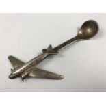 A vintage novelty electroplate preserve spoon the terminal modelled as an aeroplane, 13 cm