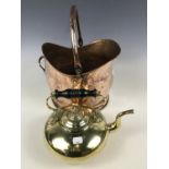 A copper coal helmet and a brass kettle