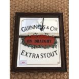A Guinness & Co's on Draught Extra Stout bar mirror