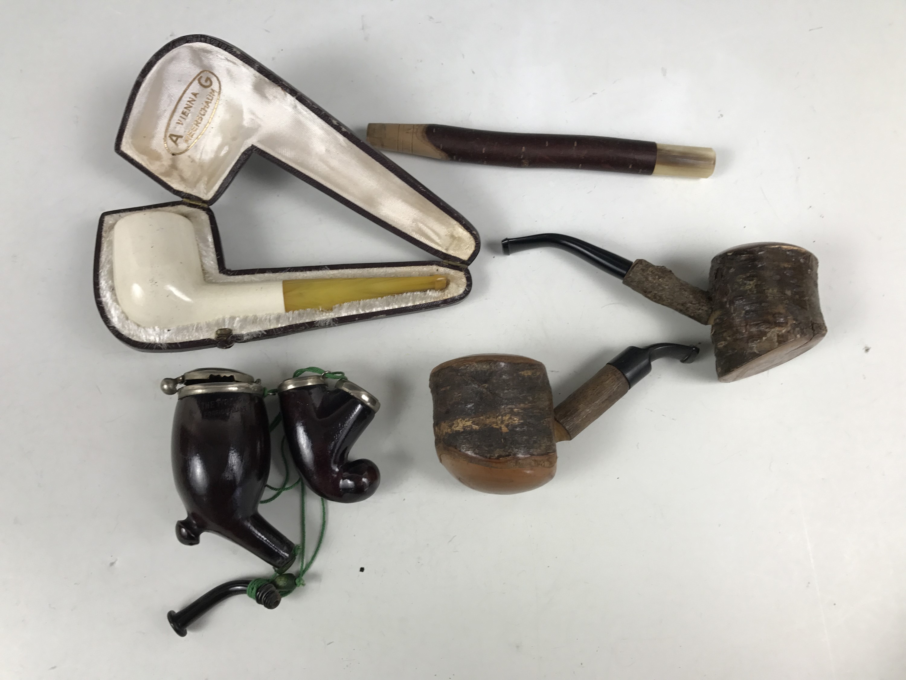 A cased Vienna meerschaum pipe together with others