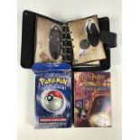 A Harry Potter trading card game together with a Pokemon trading card game and a Harry Potter coin