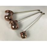 Three copper and brass measuring ladles