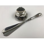 A George V silver capstan inkwell, together with a George V silver handled shoe horn