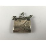 A miniature silver purse