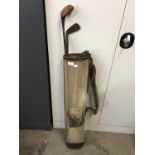A vintage golf bag together with a C&W St Andrews wood, and two irons