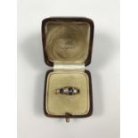 An early 20th Century five stone sapphire and diamond ring, the graded stones being held in an