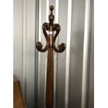 A contemporary carved mahogany coat stand