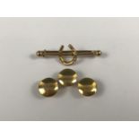 Three 9ct gold shirt studs, together with a 9ct gold stock pin with horseshoe surmount, 2.7g