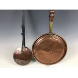 A copper bed warming pan together with a chestnut roaster