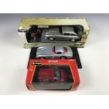 A 007 remote control Aston Martin DB5 together with a model Mercedes Benz 300 SLR coupe and a