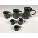 Six antique pewter measures