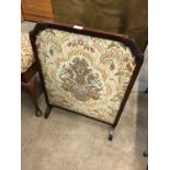 A floral embroidered fire screen