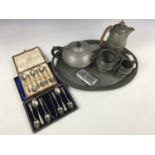 A 1920s "Castle Pewter" part tea service and tray, together with a similar teapot, two cased sets of