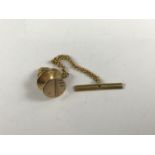 A gentleman’s 9ct gold solitaire / tie pin, having engine turned decoration and gilt metal