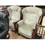 A pair of beige upholstered armchairs