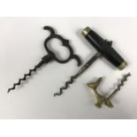 Three corkscrews including one with an Art Deco style cast-brass handle modelled as a dog