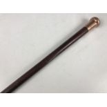 A gentleman's 9ct gold mounted walking cane, engraved 'Presented to J. Higson by his Workhands at