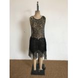 A 1920s black lace "Flapper" dress, having boat neck, dropped waist and layered skirt with