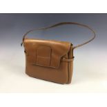 A vintage Delvaux cognac leather handbag, with cream top stitching, having a frontal pouch with