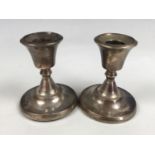 A pair of George V silver diminutive candlesticks, Birmingham, 1926, loaded