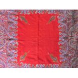 A late 19th / early 20th Century woven paisley shawl, of Indian origin, having a scarlet cotton