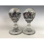 A pair of Victorian "end of day" footed glass paperweights, 14 cm