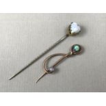An early 20th Century yellow-metal and opal patented stick pin, bearing design registration mark,