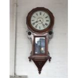 A Victorian rosewood drop dial wall clock, having a spring-driven two-train movement striking on a