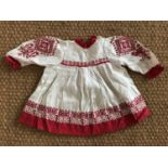 An early 20th Century child's Bohemian influenced cotton dress, of white self-patterned cotton
