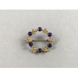 An early 20th Century split seed pearl and amethyst wreath brooch, the pearls sunken set in a