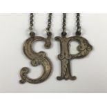 A pair of Victorian silver bottle tickets, in the form of the letters 'S' and 'P', each with