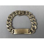 A gentleman's 9ct gold identity bracelet, having bark effect curb links, 68g