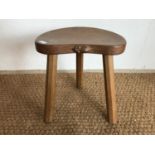 A Robert "Mouseman" Thompson (1876-1955) carved oak cow stool, having kidney shaped adzed top and