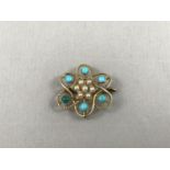 A late Victorian turquoise and split seed pearl openwork pendant brooch, in a flower-head