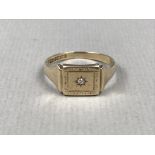 A gentleman's diamond set 9ct gold signet ring, the rectangular face being gypsy set with a